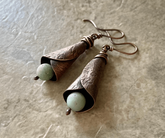 Rustic handmade copper cone earrings with engraved texture and green gemstone bead drop